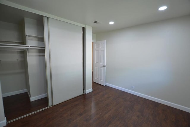 unfurnished bedroom with dark hardwood / wood-style floors