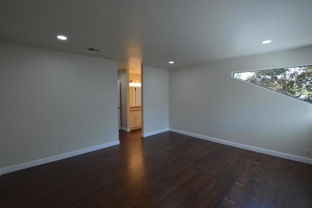 empty room with dark hardwood / wood-style flooring