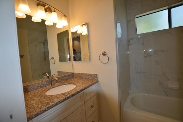 bathroom with vanity and tiled shower / bath combo