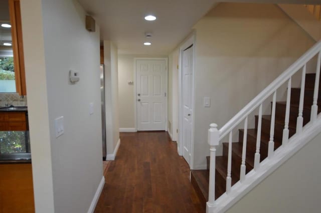 hall featuring dark hardwood / wood-style flooring and sink