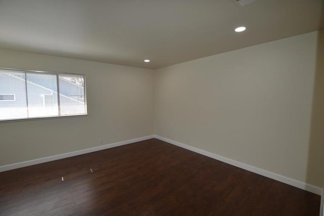 spare room featuring dark hardwood / wood-style flooring