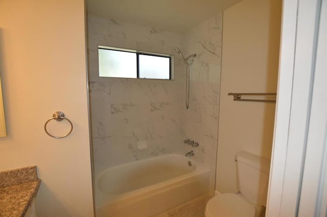 full bathroom featuring vanity, tiled shower / bath combo, and toilet