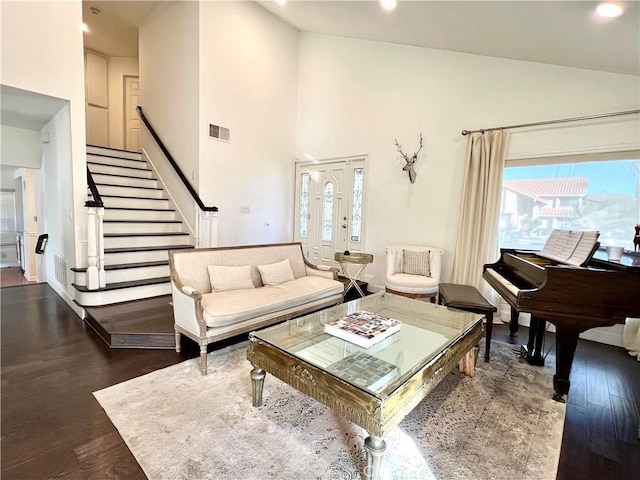 living room featuring dark hardwood / wood-style floors and high vaulted ceiling