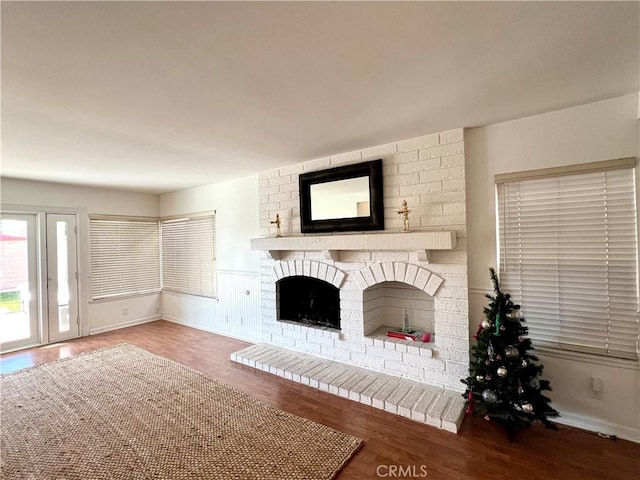 unfurnished living room with hardwood / wood-style flooring and a fireplace