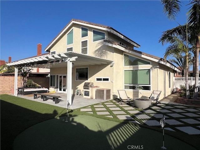 back of house with a patio area, central AC, an outdoor kitchen, and a pergola