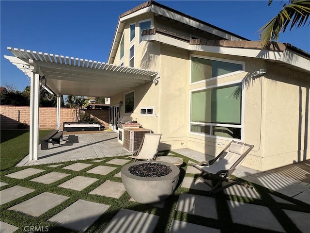 view of patio / terrace with cooling unit and a fire pit