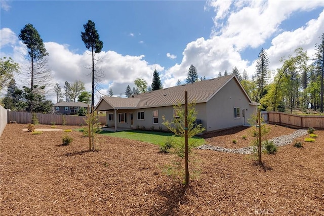 rear view of property featuring a yard