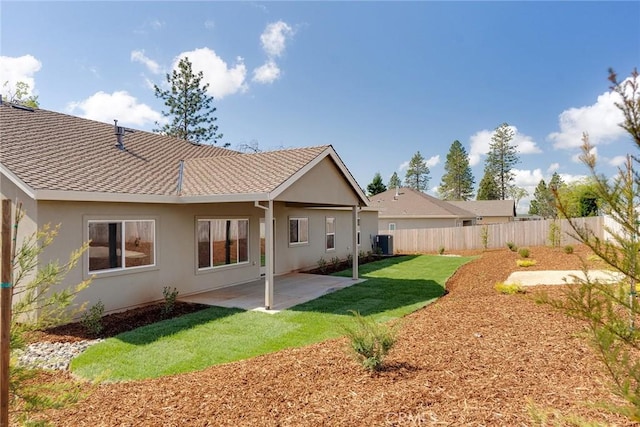 back of property with cooling unit, a yard, and a patio