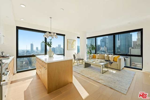 living room with light hardwood / wood-style floors and a notable chandelier