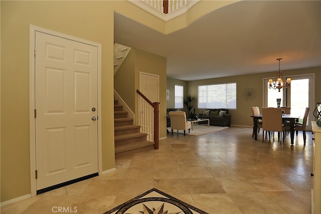 foyer with a chandelier