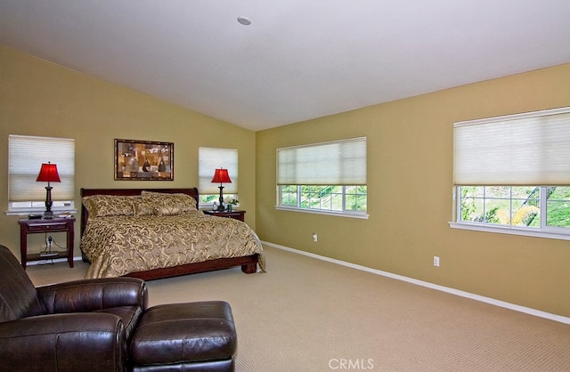 bedroom with multiple windows, carpet flooring, and lofted ceiling