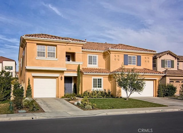 mediterranean / spanish-style home featuring a garage