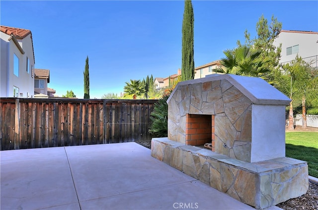 view of patio / terrace featuring an outdoor stone fireplace