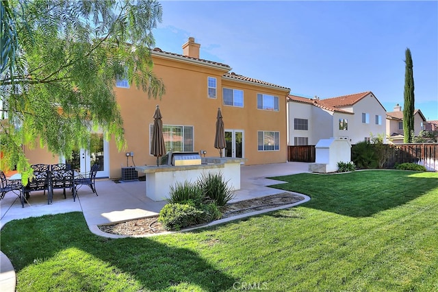 back of property with a patio, a yard, and central AC unit