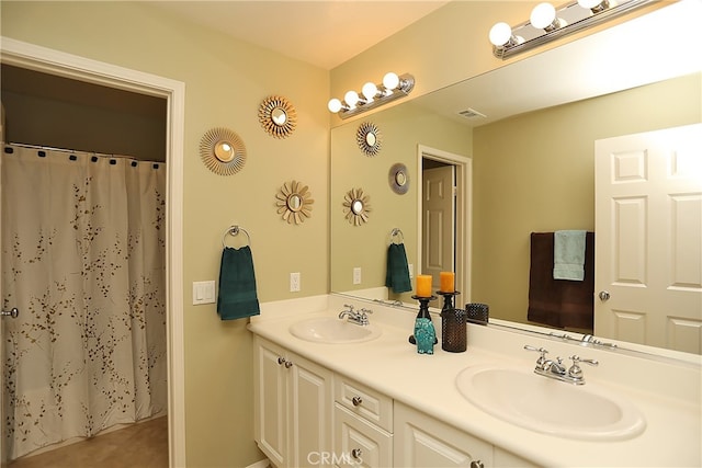 bathroom featuring vanity and curtained shower