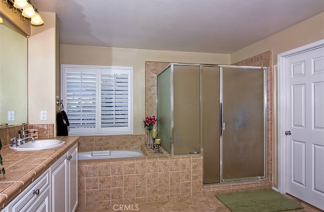 bathroom with vanity, shower with separate bathtub, and tile patterned flooring