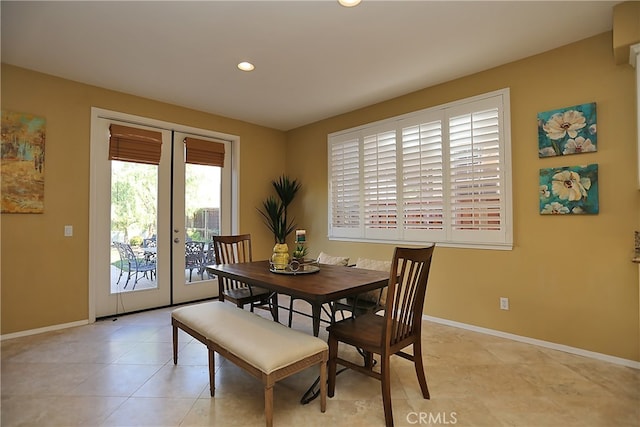 tiled dining area featuring french doors