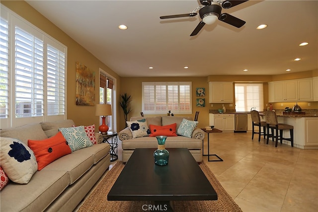 tiled living room with ceiling fan and a wealth of natural light