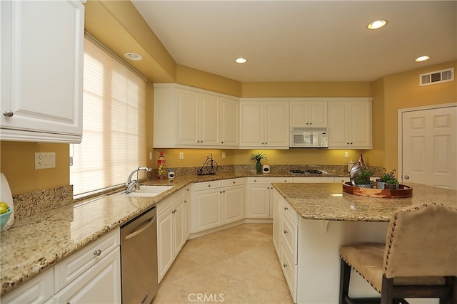 kitchen featuring white cabinets, stainless steel appliances, and sink