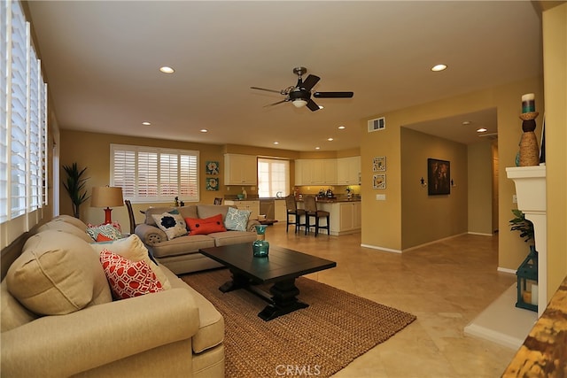 tiled living room with ceiling fan