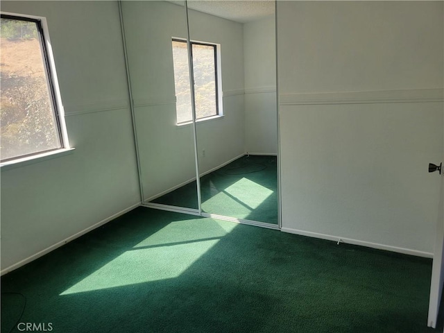 unfurnished bedroom featuring carpet floors and a closet