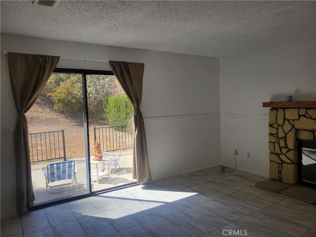 unfurnished living room featuring tile patterned flooring and a textured ceiling