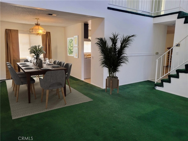 dining room featuring a notable chandelier and carpet floors