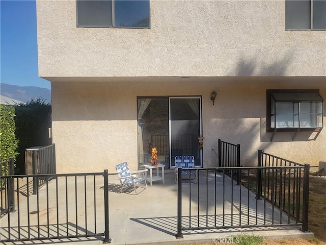 rear view of property featuring a mountain view and a patio