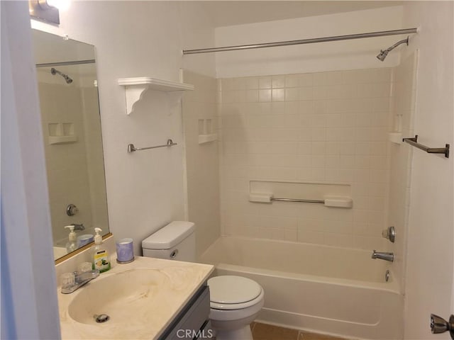 full bathroom featuring tile patterned floors, tiled shower / bath combo, toilet, and vanity