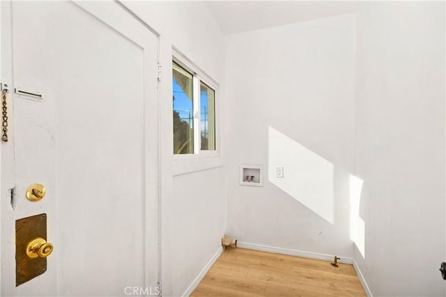 3959 Denker Ave, Los Angeles, CA 90062 - laundry room with light wood-style floors, washer hookup, and baseboards