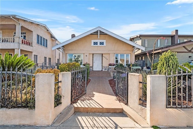 3959 Denker Ave, Los Angeles, CA 90062 - view of front facade with a fenced front yard, stucco siding, and a gate