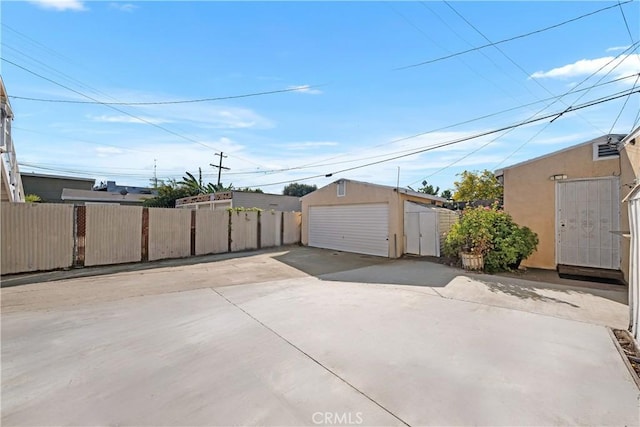 3959 Denker Ave, Los Angeles, CA 90062 - exterior space featuring a detached garage, an outdoor structure, and stucco siding