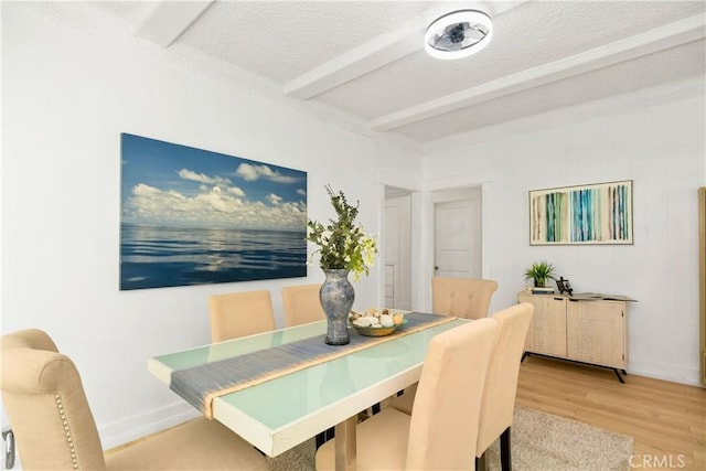 3959 Denker Ave, Los Angeles, CA 90062 - dining area with beamed ceiling, baseboards, light wood-type flooring, and a textured ceiling