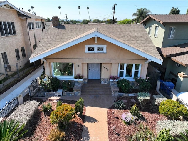 3959 Denker Ave, Los Angeles, CA 90062 - view of front facade with roof with shingles, a gate, and stucco siding