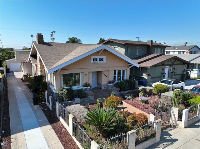 3959 Denker Ave, Los Angeles, CA 90062 - bungalow featuring a fenced front yard, stucco siding, a gate, a garage, and a chimney