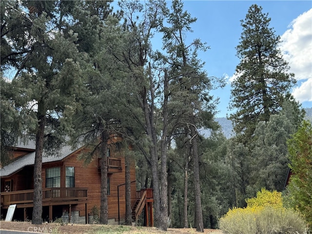 view of property exterior with a wooden deck