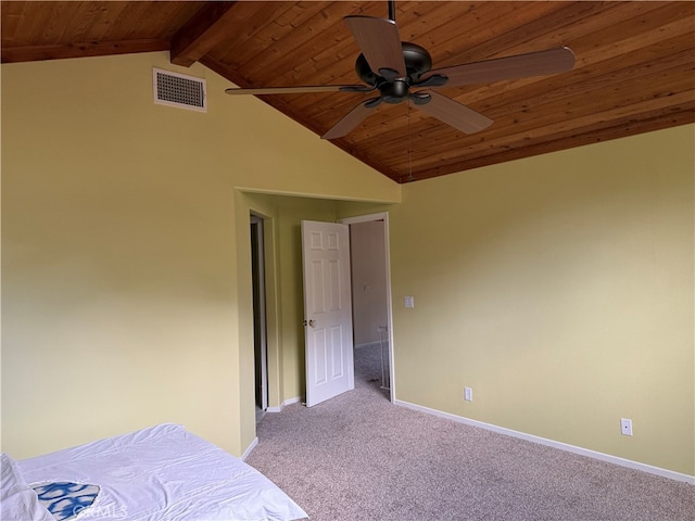 unfurnished bedroom with lofted ceiling with beams, light colored carpet, wooden ceiling, and ceiling fan