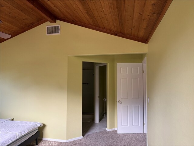 unfurnished bedroom with light carpet, vaulted ceiling with beams, and wood ceiling