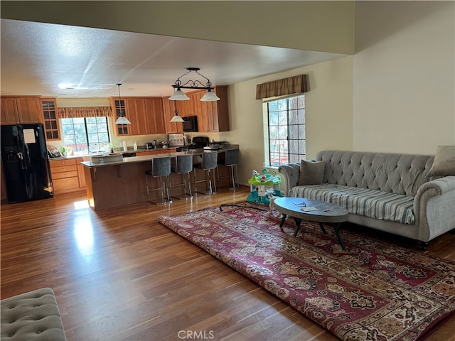 living room featuring a textured ceiling and wood-type flooring