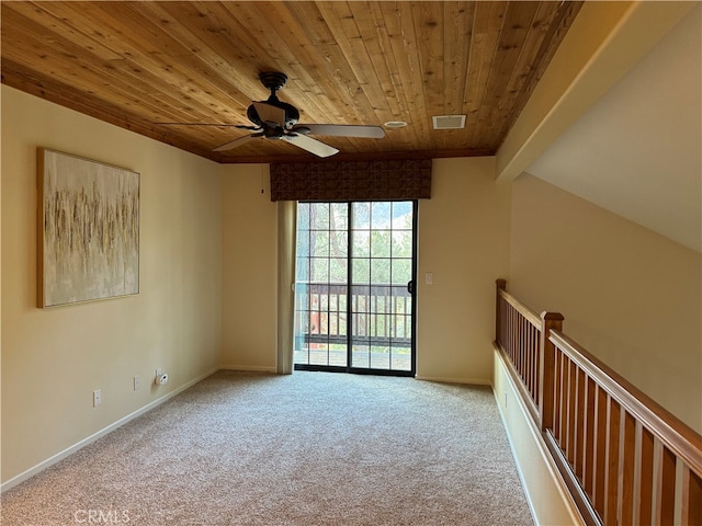 empty room with wood ceiling, carpet, beamed ceiling, and ceiling fan