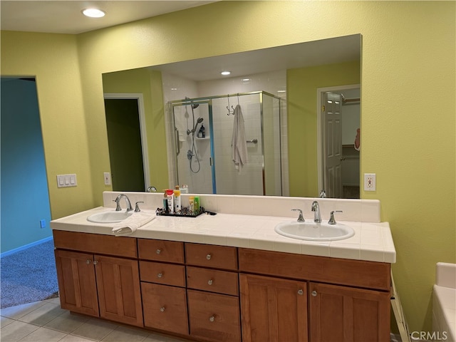 bathroom featuring vanity, tile patterned floors, and walk in shower