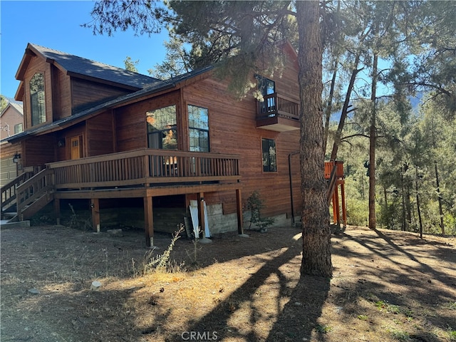 back of property featuring a wooden deck