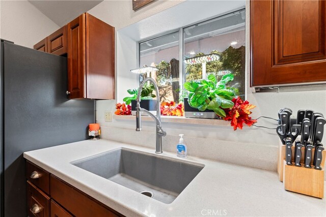 kitchen with stainless steel fridge and sink