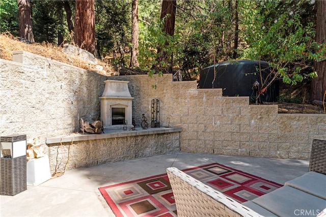 view of patio with exterior fireplace