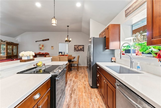 kitchen with sink, stainless steel appliances, vaulted ceiling, and light hardwood / wood-style flooring