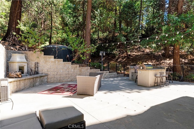 view of patio with exterior fireplace