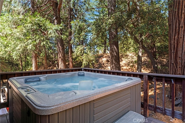 exterior space featuring a hot tub and a wooden deck