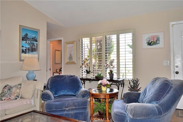 sitting room with vaulted ceiling