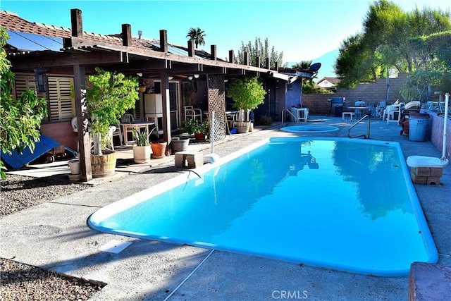 view of pool with a patio area and a grill