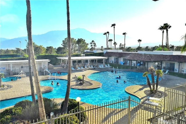 view of pool featuring a mountain view and a patio area